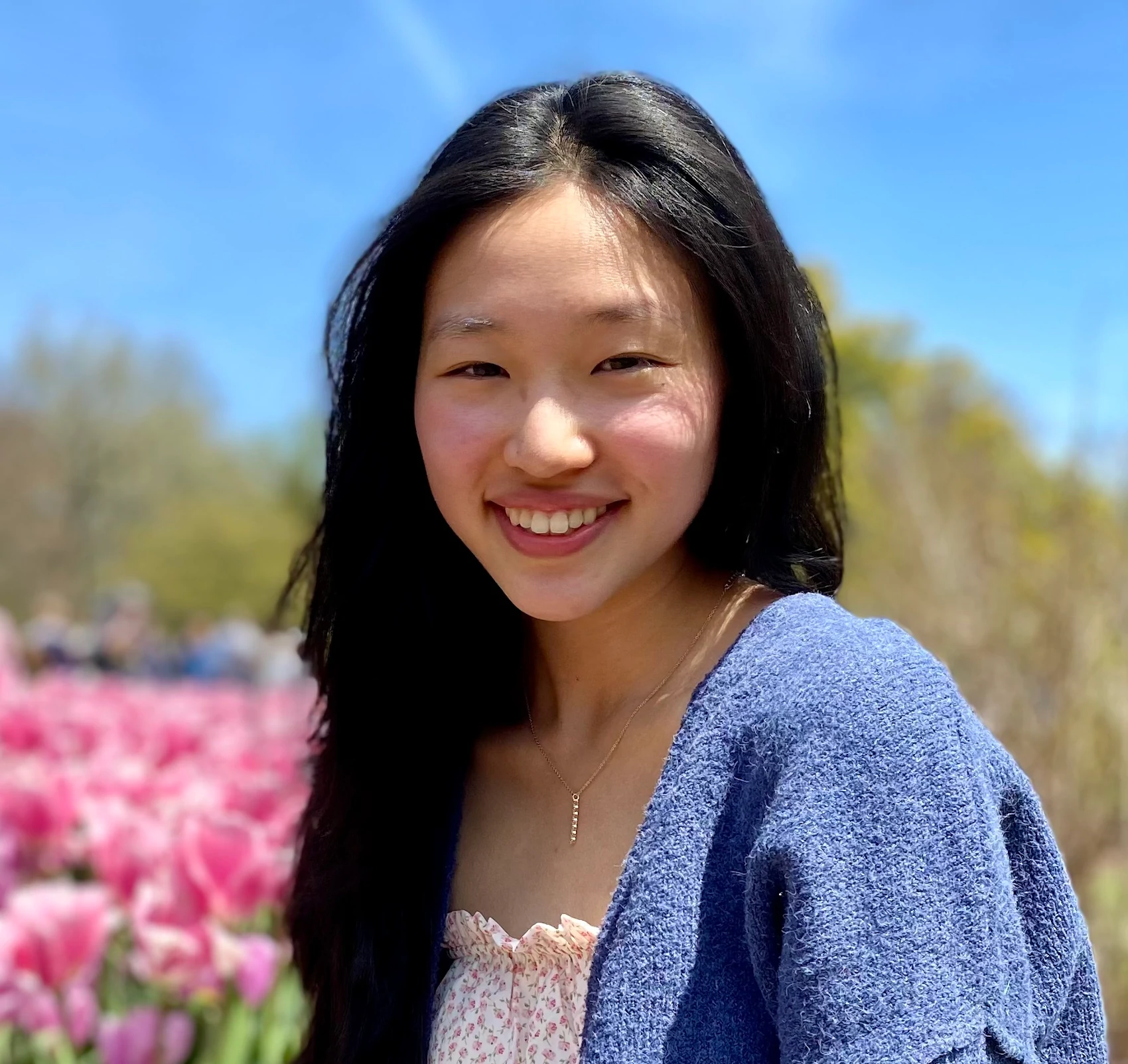 Priscilla smiles in a sunny field of flowers